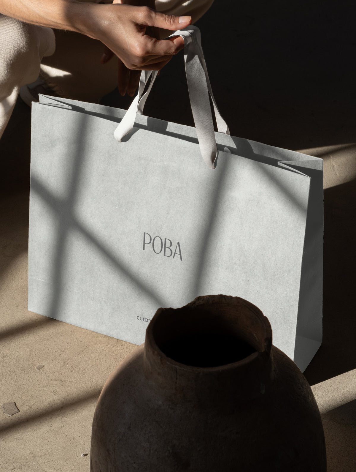 POBA shopping bag with the wordmark, in soft daylight