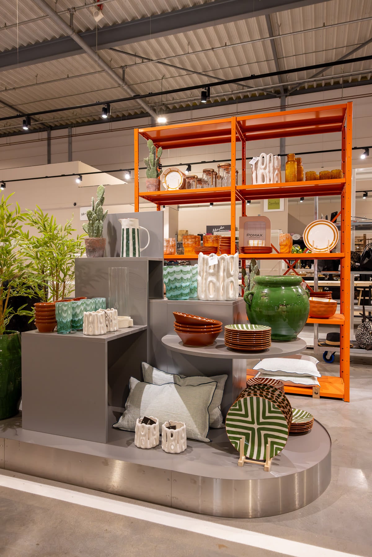 Display of grey blocks on a stainless steel podium with an orange rack
